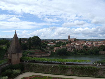 View of city against cloudy sky