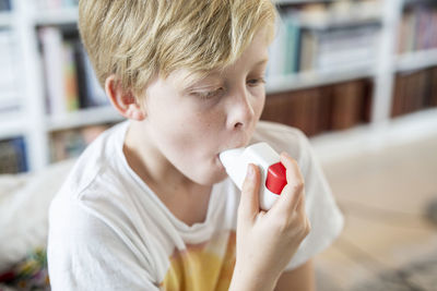 Boy using inhaler