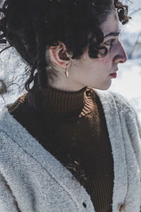 Side view of young woman looking away