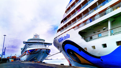 Ship moored in city against sky