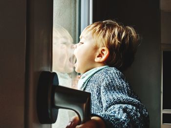 Side view of cute boy at home