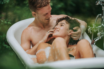 Midsection of man with baby outdoors