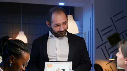 Young man using mobile phone in office