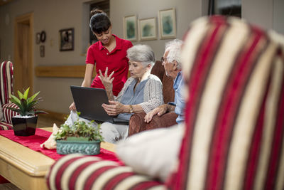 Seniors at retirement home looking at photo albums