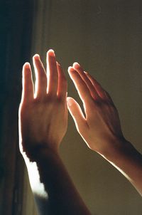 Close-up of human hand against black background