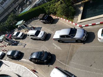 High angle view of vehicles on road along buildings