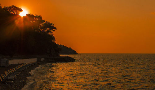 Scenic view of sea against sky at sunset