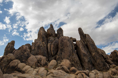 Low angle view of rock formation against sky in desert landscape