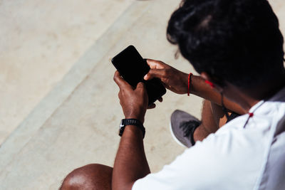 High angle view of man holding mobile phone