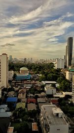 Buildings against cloudy sky