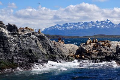 Scenic view of sea and mountains against sky