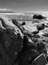 Rocks on beach against sky