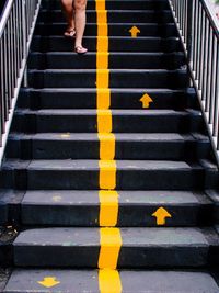 Low section of woman walking on steps