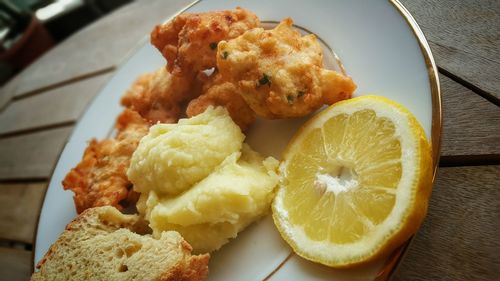 Close-up of fried fish along with bread slices