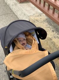 High angle view of baby in carriage on footpath