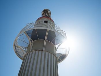 Low angle view of water tower against clear blue sky