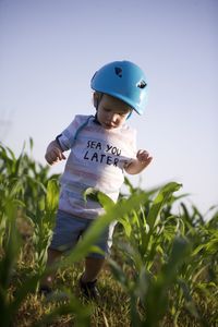 Boy standing amidst plants