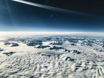 Snow covered landscape against sky