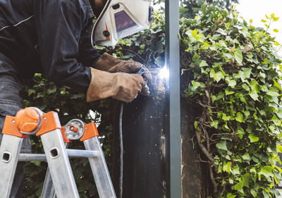 Construction worker with welding torch working at construction site