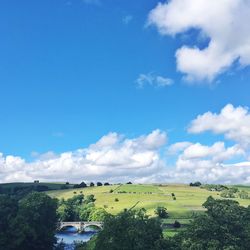 Scenic view of landscape against blue sky