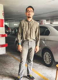 Portrait of man standing in car