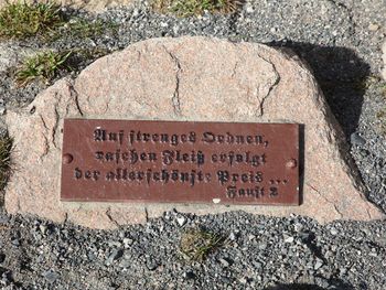 High angle view of text on stone at cemetery