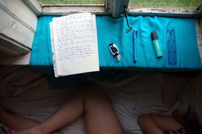 High angle view of woman sitting on bed