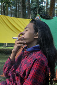 Young woman smoking cigarette