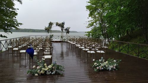 Wedding. ceremony. wedding arch and white chairs on terrace after rain