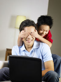 Son covering eyes of father