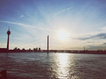 Bridge over river against cloudy sky