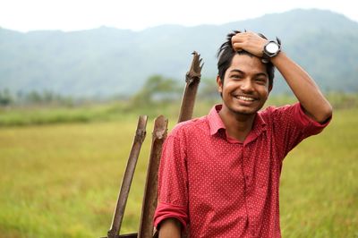 Portrait of smiling young man standing outdoors