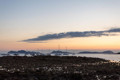 Scenic view of land against sky during sunset