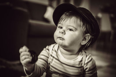 Close-up of cute baby boy sitting at home