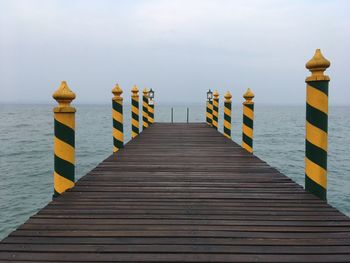 Pier over sea against sky