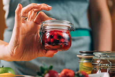 Close-up of hand holding glass jar