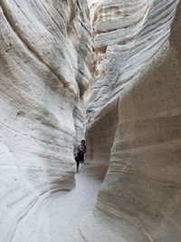 Woman standing amidst tent rocks