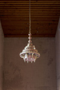 Close-up of chandelier hanging against wall