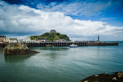 Scenic view of sea against buildings in city