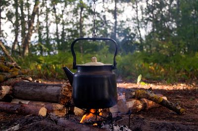 Close-up of kettle on campfire in forest