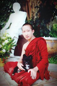 Portrait of teenage girl sitting with dog