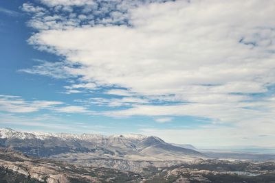 Scenic view of snowcapped mountain against cloudy sky