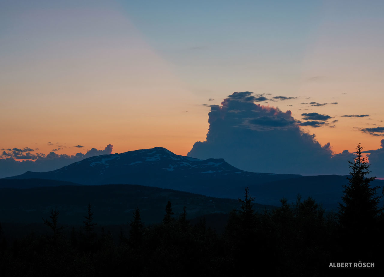 SCENIC VIEW OF SILHOUETTE MOUNTAIN AGAINST SKY AT SUNSET