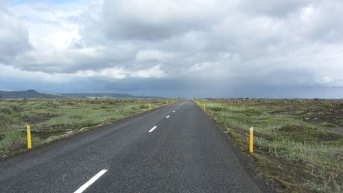 Empty road against storm clouds