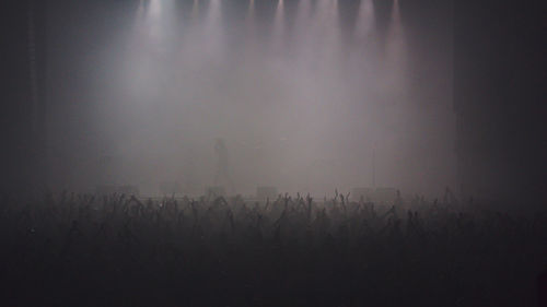 Silhouette of people on field at dusk