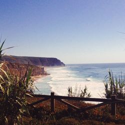 Scenic view of beach against blue sky