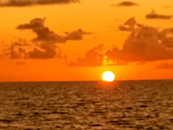 Scenic view of sea against orange sky