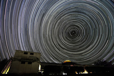 Low angle view of illuminated building against sky at night