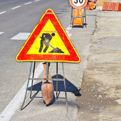 Road sign on footpath in city