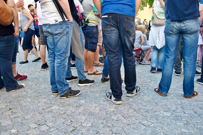 Low section of people standing on footpath